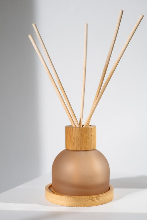 a diffuser container with reed sticks