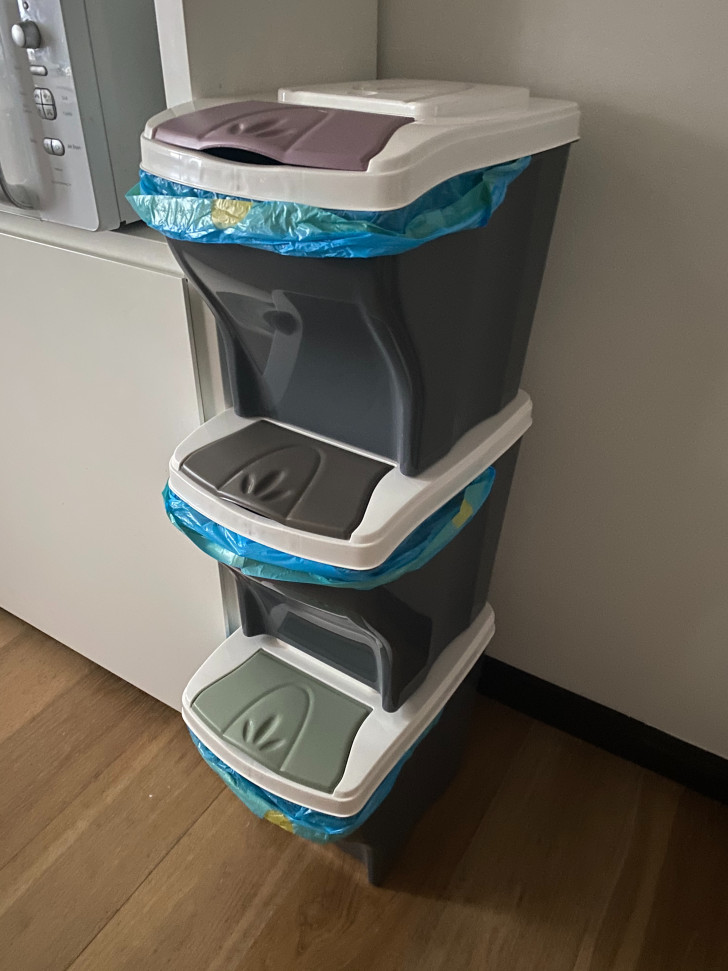 three waste sorting bins stacked on top of each other