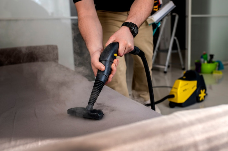 treating a sofa with a steam cleaner