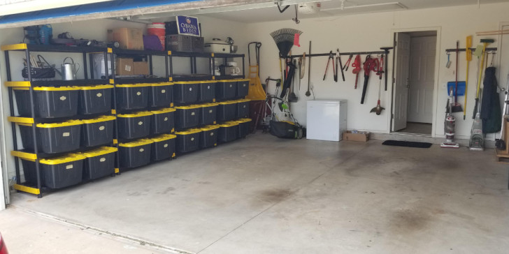 A neatly organized garage with wall-mounted shelving