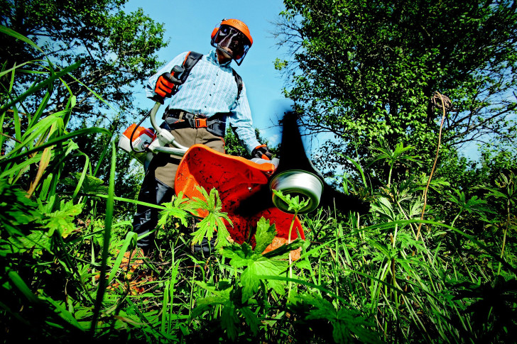 a brush cutter in operation, photographed from below