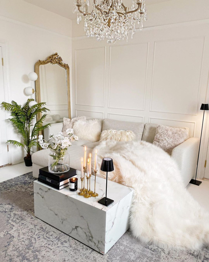 A large, floor-standing mirror placed next to a sofa in a living room