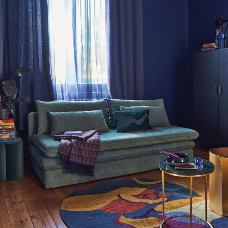 a blue sofa bed that matches the room's decor