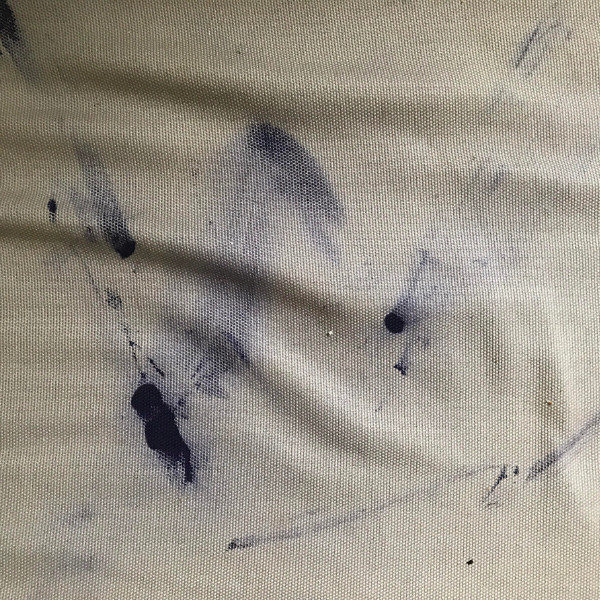 Ink stains on the seat of a fabric-covered sofa