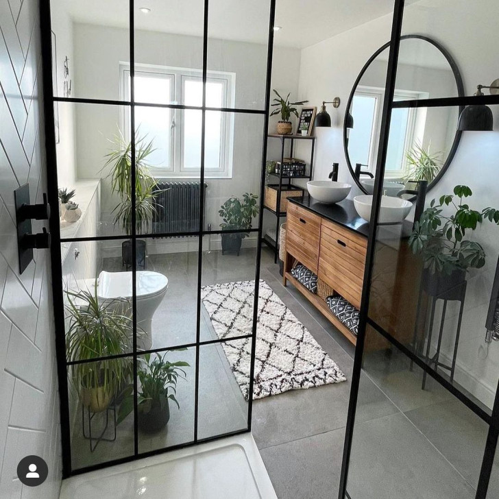 A bathroom with geometrically balanced lines and neutral colors enhances the natural light