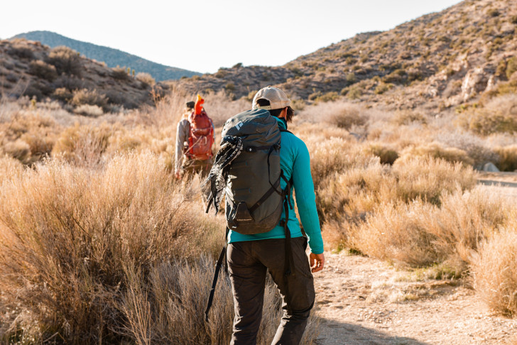 two people with backpacks on a hike