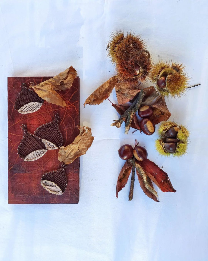 Chestnuts, burrs and leaves next to a display of chestnuts made with nails and wire