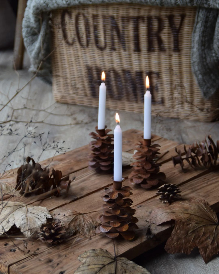 Autumnal candle holders made with pine cones