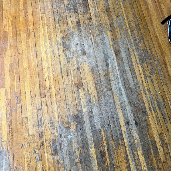 A wooden floor with dark stains