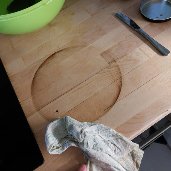 A bamboo worktop with a significant burn mark