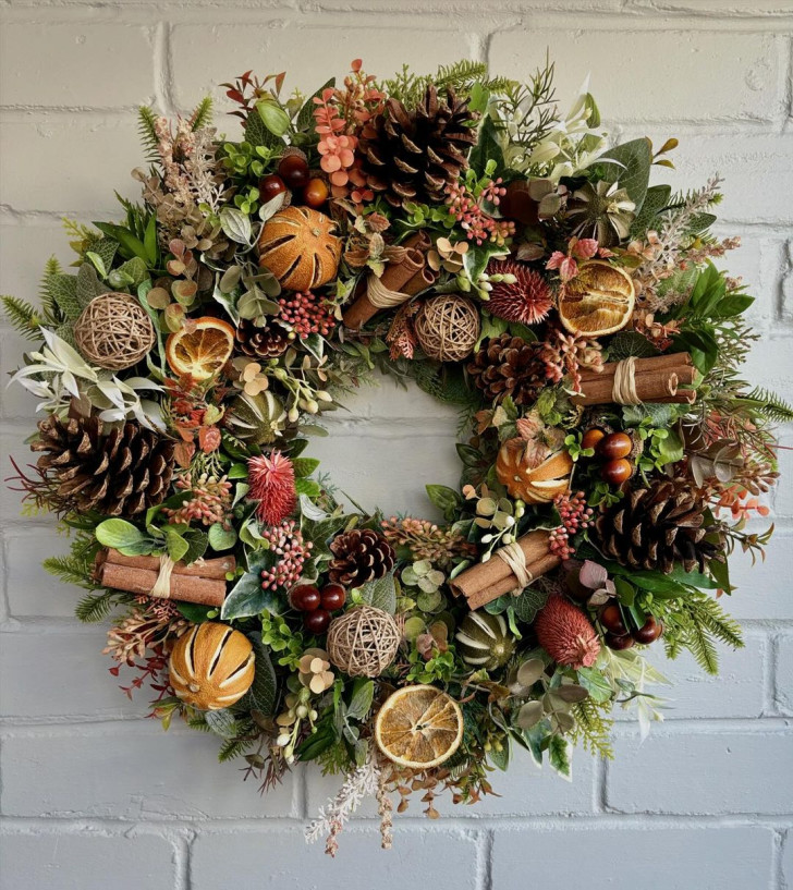 Wreath with pine cones, cinnamon and dried mandarins