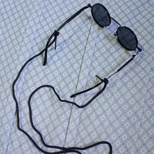 A pair of glasses with a shoelace as a neck cord