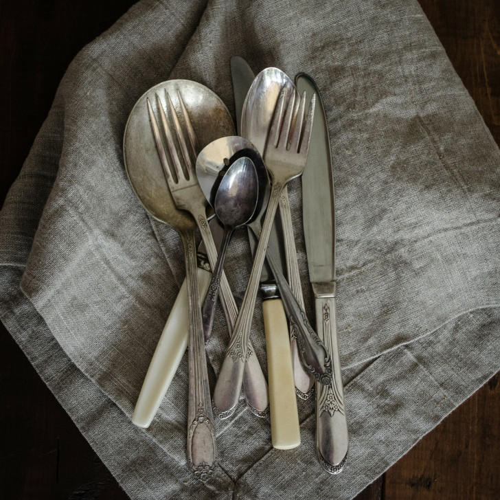 antique silverware on a kitchen towel