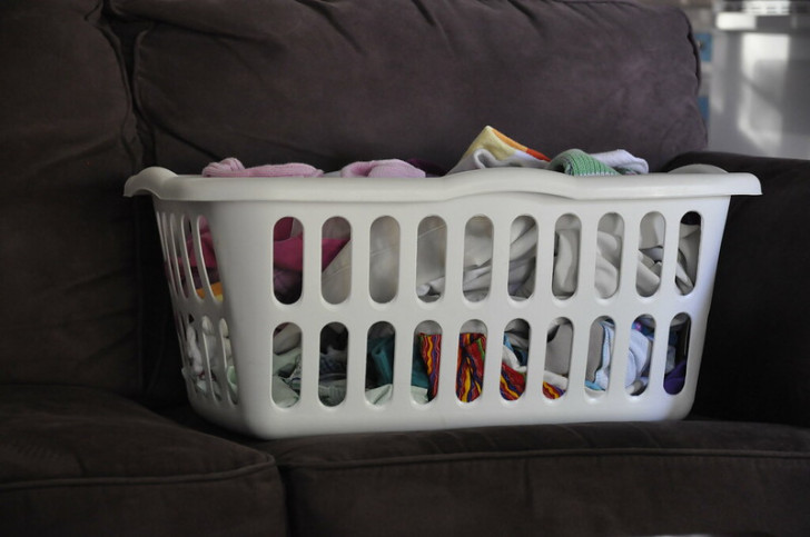 A laundry hamper full of colored clothes