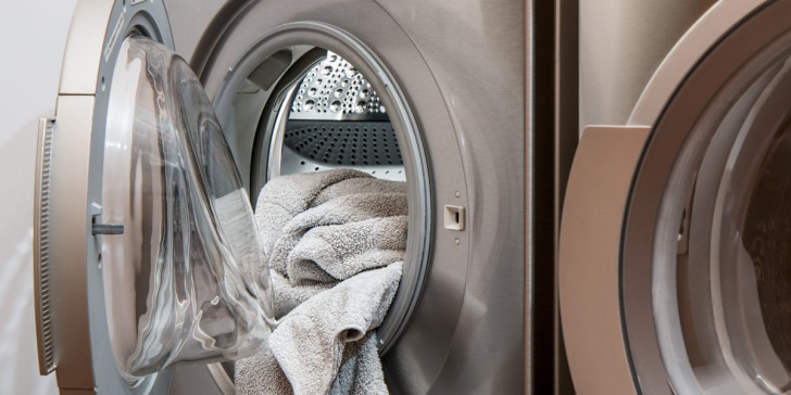 A towel being taken out of a dryer