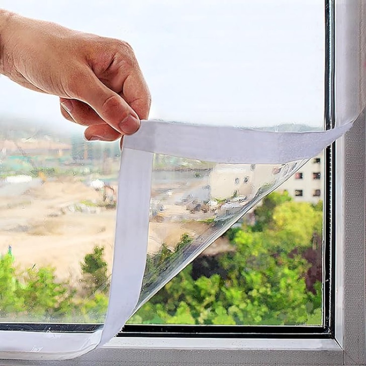 a clear, insulating film being applied to a window