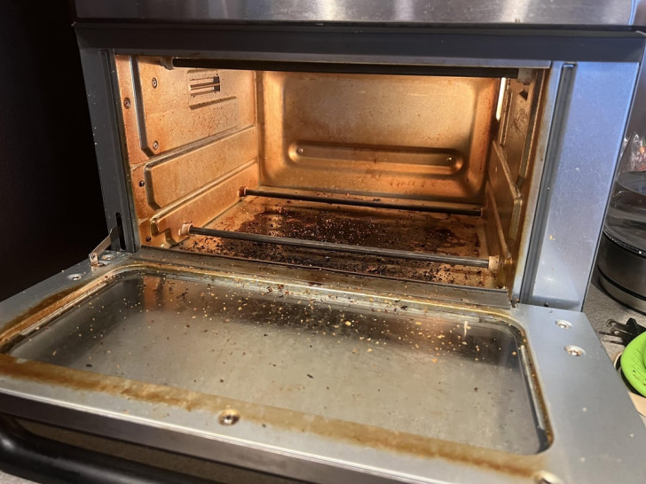 an oven with a very dirty internal cooking compartment