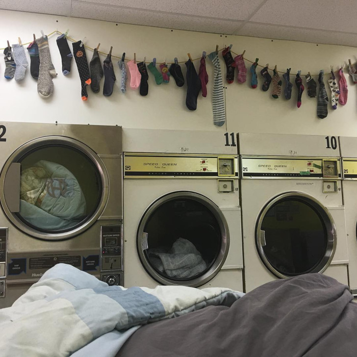 A weighted blanket being washed at a laundromat