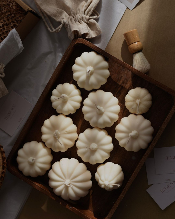 white, soy wax candles in the shape of small pumpkins