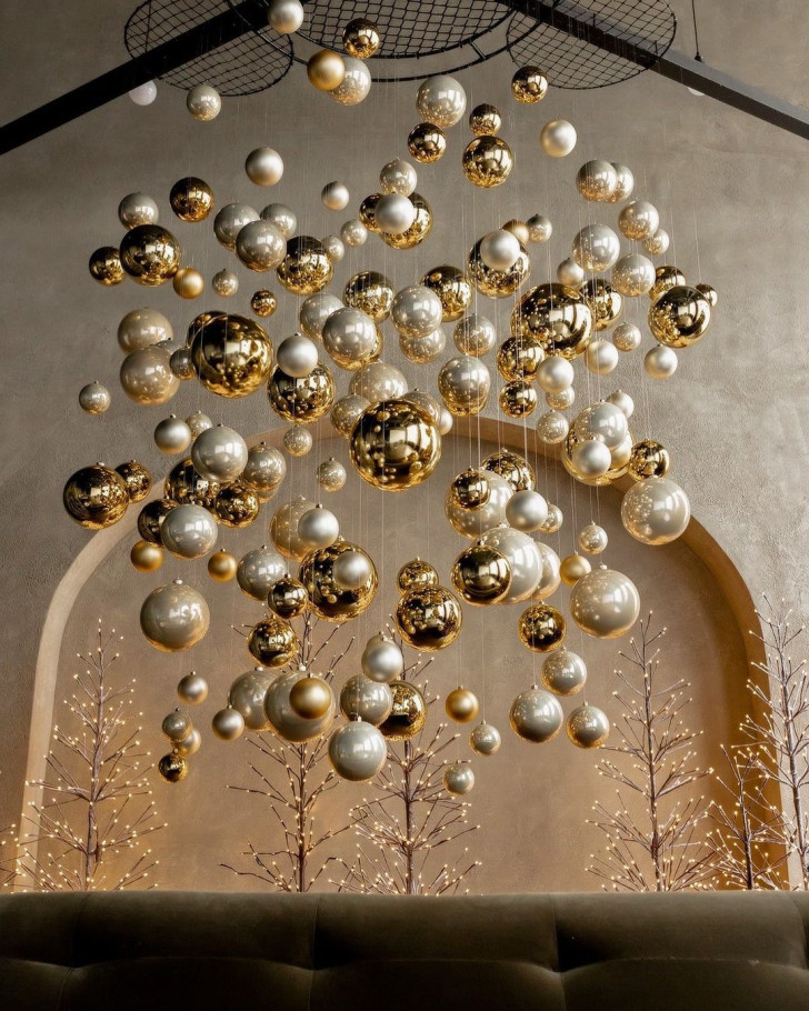 golden Christmas ball ornaments hanging from a ceiling