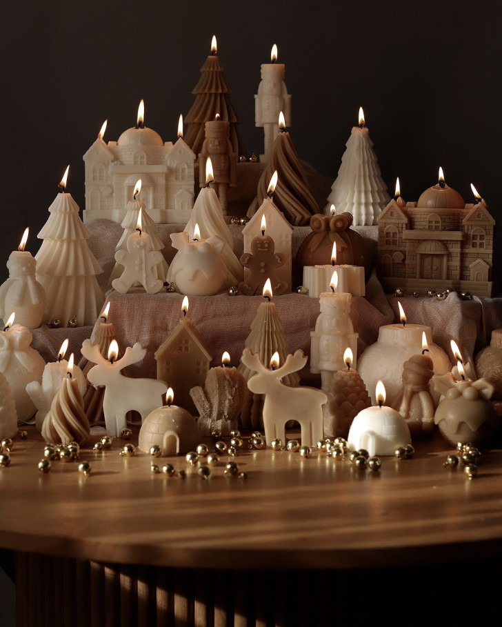 a group of Christmas candles arranged to look like a tiny village