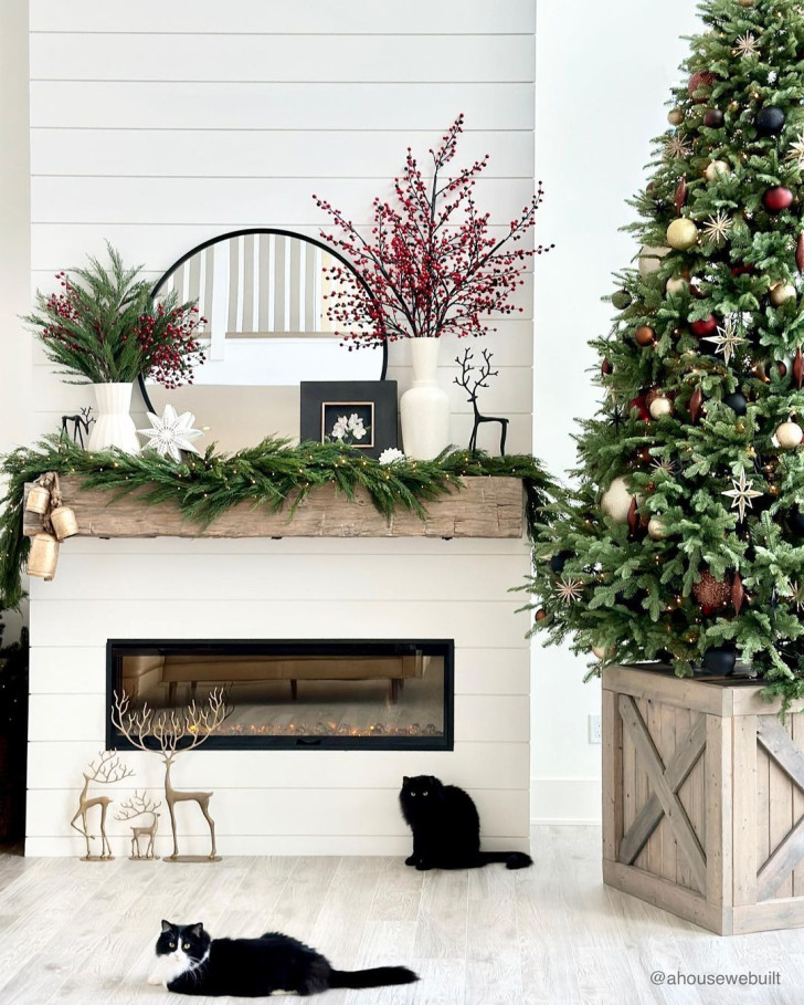 An elegant-looking fireplace decorated with lights and natural materials