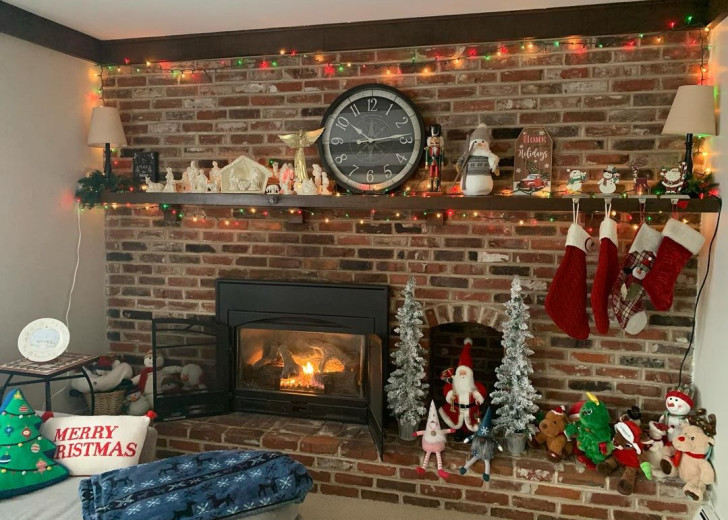 A fireplace decorated with the traditional symbols and icons of Christmas