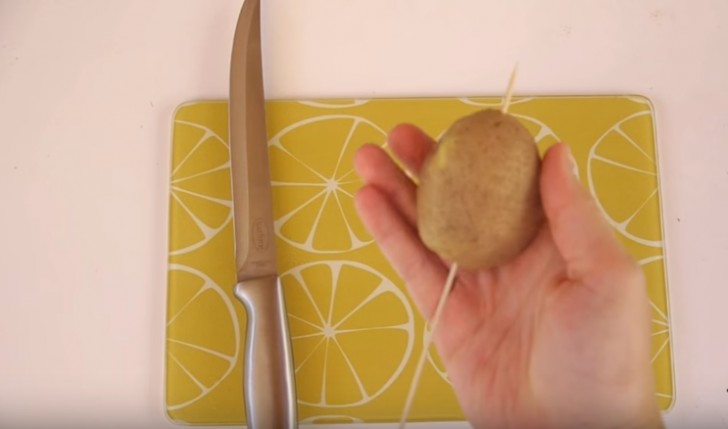 Inserite lo stecchino nella patata, facendone sporgere solo qualche centimetro al di sopra.