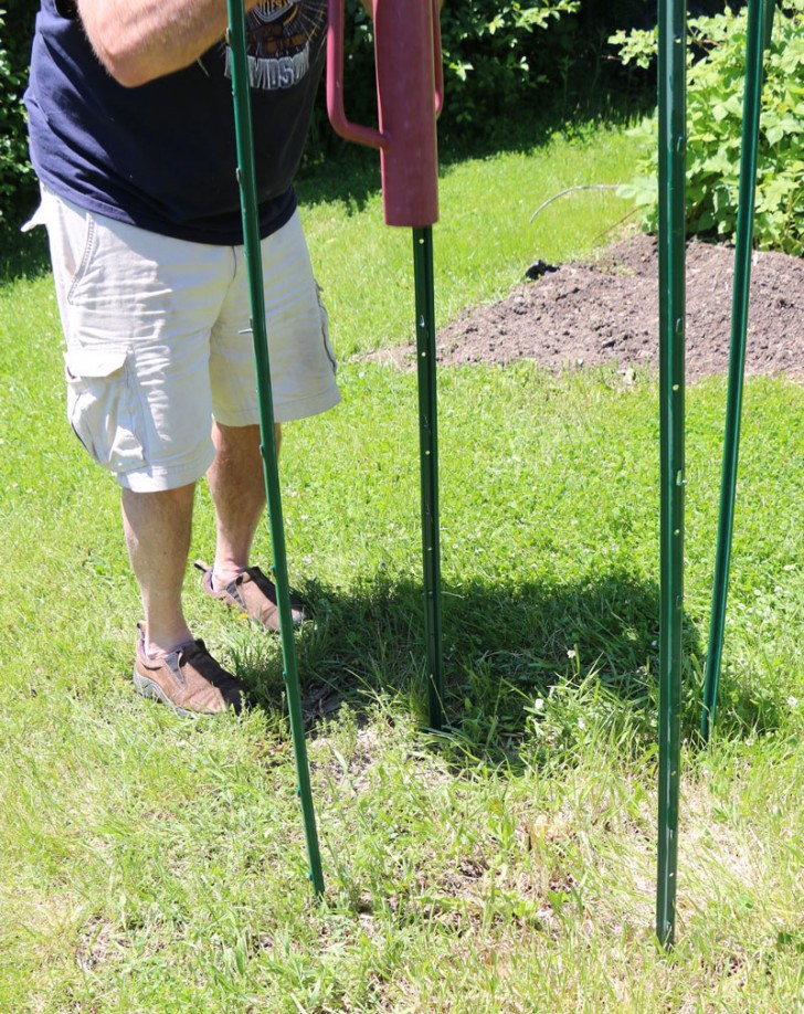 Laurie and her husband positioned the four steel posts in the ground to form a square. The size of the area will vary based on how much free space you have available.