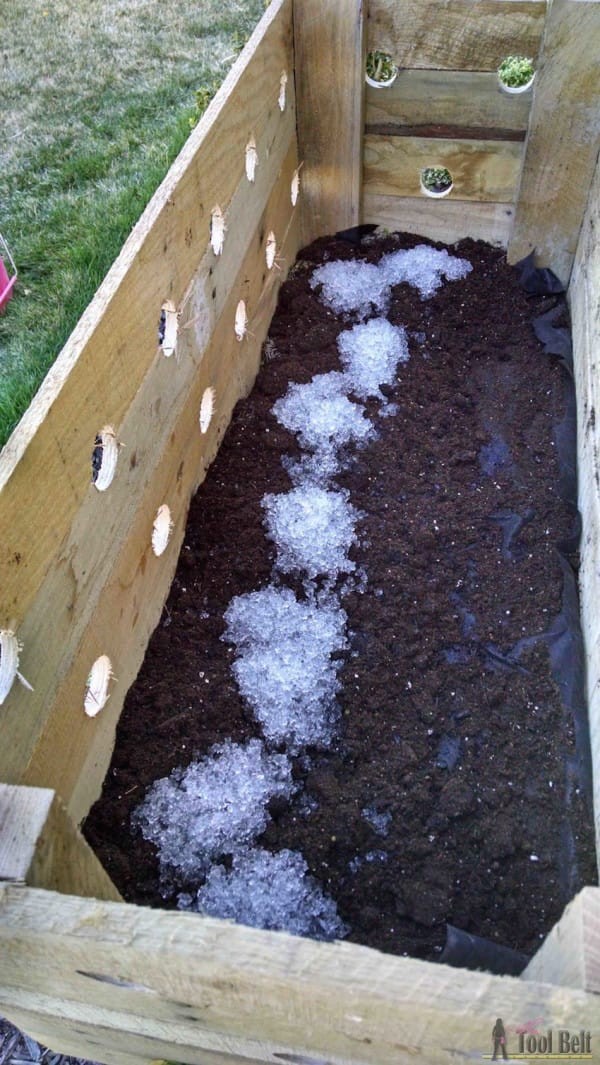 Fill the planter with soil and add fertilizer. If the box has any gaps open on the bottom, you can cover them with a tarpaulin.