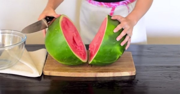 Put the watermelon on a cutting board and halve it