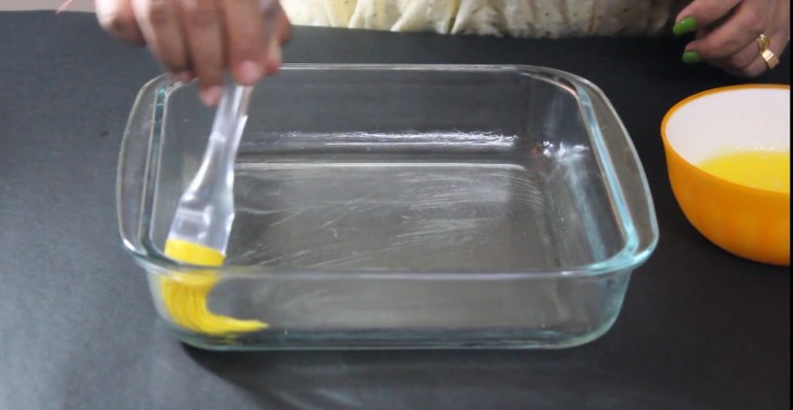 Use a baking dish suitable for a microwave oven and brush the bottom, sides, and corners with the melted butter.