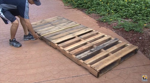 Take two wooden pallets and join them according to the length of the mattress.