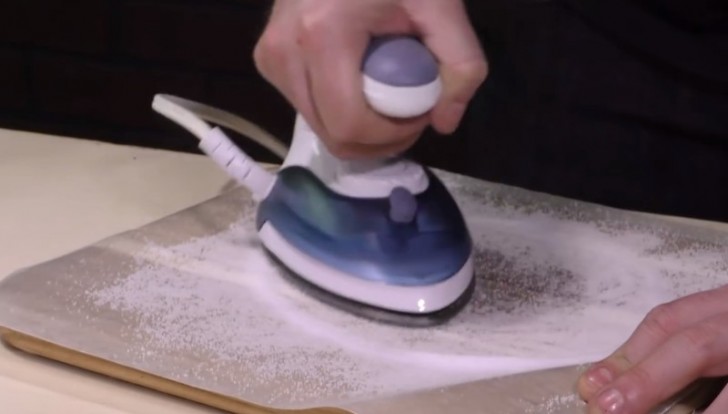 Have you used a hot iron on the wrong fabric? You can remove the sticky burnt fabric as follows --- put a sheet of parchment paper on a wooden cutting board and sprinkle with salt, then pass the hot iron over the salt. Problem solved!