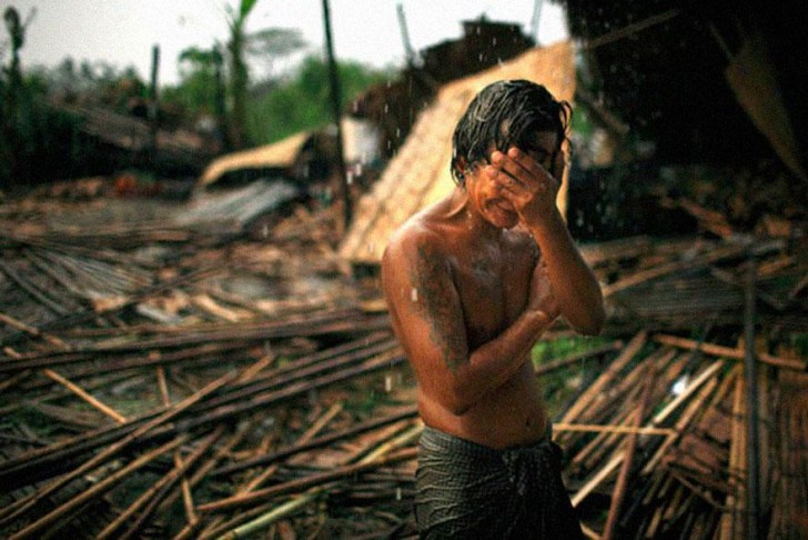 De 29-jarige Hhaing The Yu huilt naast de ruïne van zijn huis dat door de cycloon Nargis is weggevaagd in mei 2008, toen deze Myanmar aandeed.