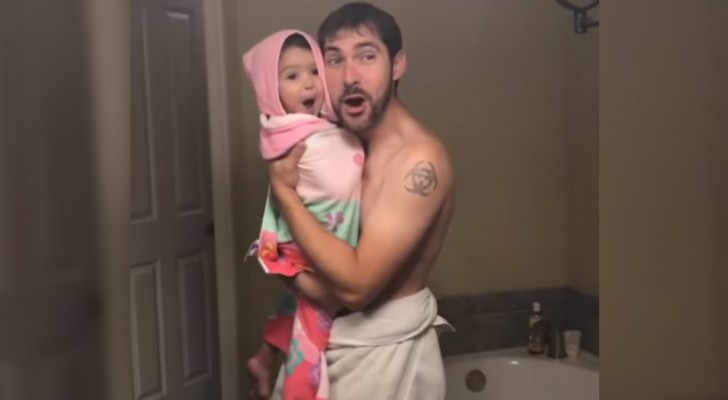 A father sings with his little daughter after she takes a shower and the tenderness of the scene will melt your heart