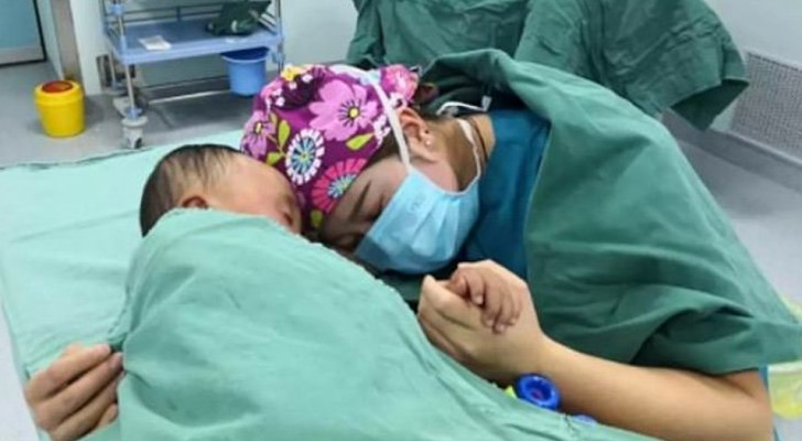 A nurse embraces a terrified child before an operation and the images go around the world