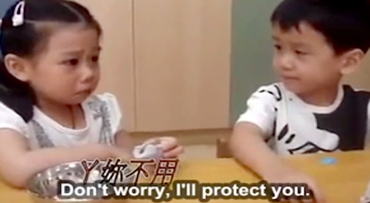 Adorable boy looks after girl on her first day of school in China