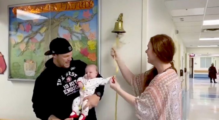  A four-month-old baby girl "rings" the bell that signifies that she is finally cancer-free