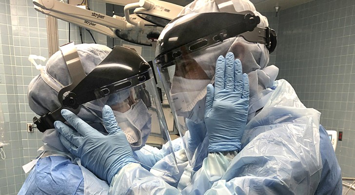 This married couple of nurses smile in the midst of the emergency: a photo symbol of love and hope