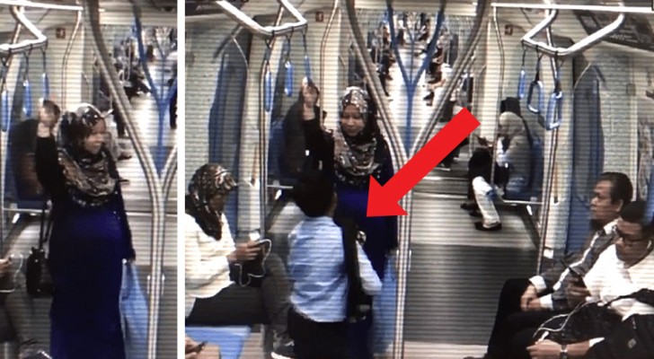 In the indifference of the other passengers, a boy gives his seat to a pregnant woman on the subway