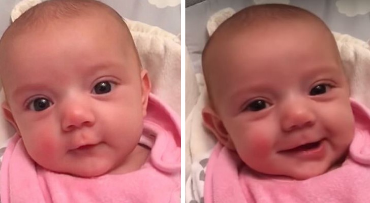 A little girl of only 8 weeks says I love you to mom and can't stop smiling at her