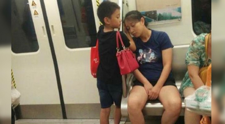 Tired mom falls asleep on the train: her child puts his hands under her head to act as a pillow