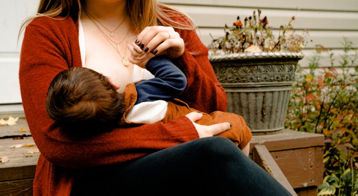 A mother is berated by a shop owner for breastfeeding her baby in public