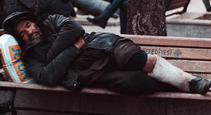 A man takes off his pants and gives them to a homeless man begging in the cold