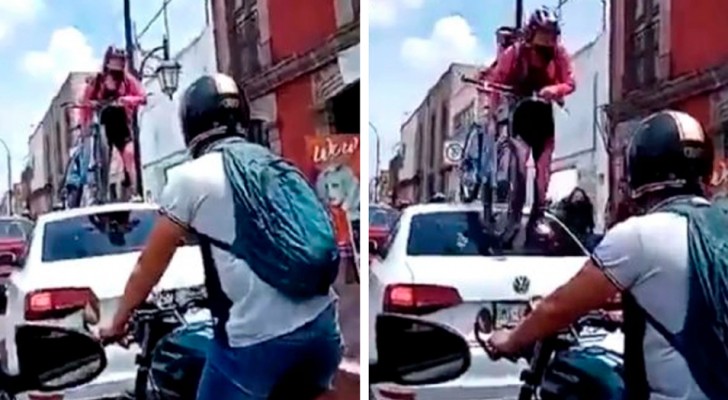 Um carro bloqueia a ciclovia: uma ciclista sobe em cima dele com a bicicleta 