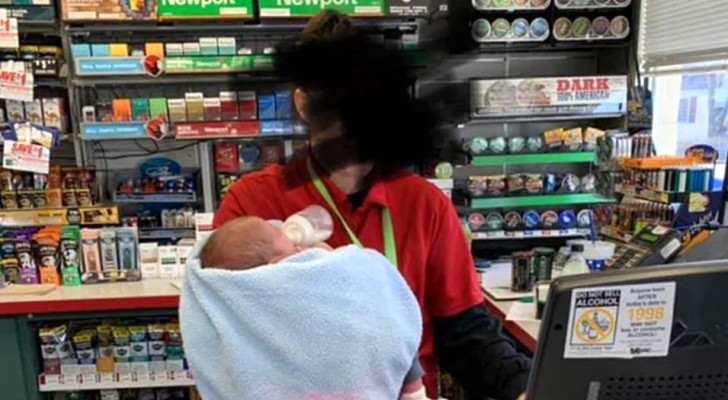 Photo of cashier holding her new baby while working is posted as motivational, but sparks controversy instead