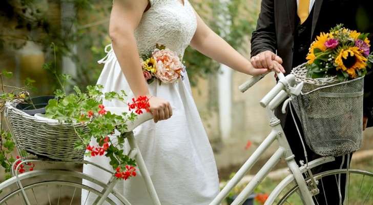 Father transports his daughter to her wedding on a bicycle decorated with flowers and balloons