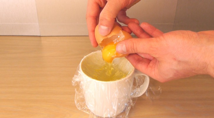 He breaks an egg in a strip of cling film and shows you an AMAZING trick !