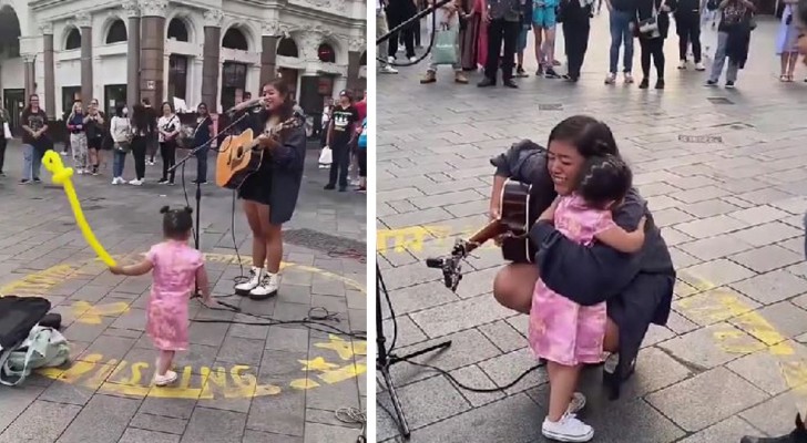 Little girl is fascinated by the music of a street artist and does not want to go home: she runs over to hug her